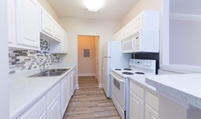 a kitchen with white cabinets