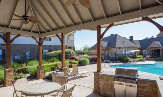 a grill area with tables and chairs